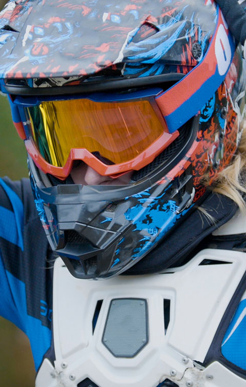 Motocross rider in full-face helmet with tinted goggles