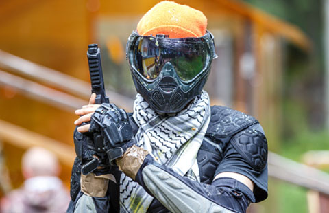Paintball player in mask holding marker